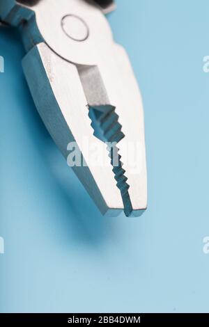 The multitool multi-function tool hovers on a blue background. The concept of an expanded multi-tool with free space. Stock Photo