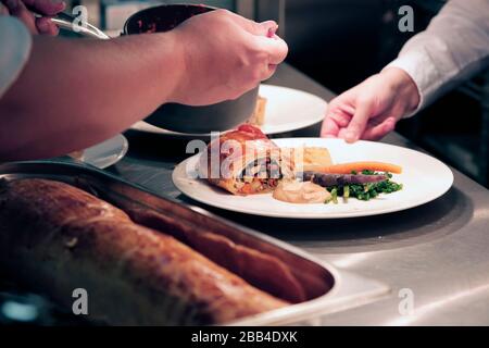 Chefs and kitchen staff at work in the kitchen at The Station Cafe Bar in Richmond, North Yorkshire, UK. 21/9/2018. Photograph: Stuart Boulton Stock Photo