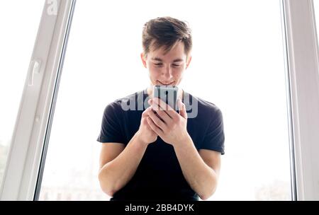 Urban man talking on smart phone. Handsome student at the cell phone. Stock Photo