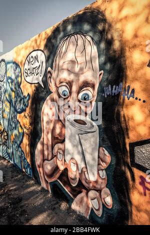 Graffiti concerning the Corona Crisis at Mauerpark in Berlin Prenzlauer Berg . Graffiti with Gollum from Lord of the Rings with toilet paper and speec Stock Photo