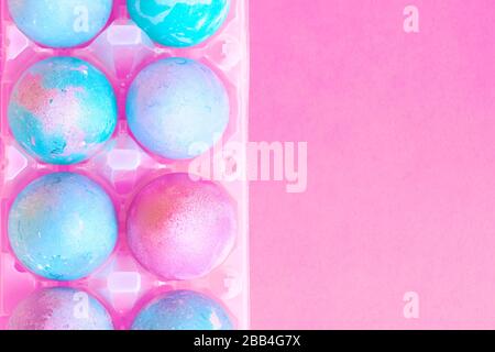 Painted Easter eggs with space intergalactic pattern in stand on magenta background Stock Photo