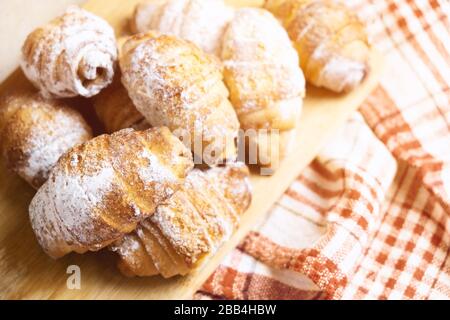 Sweet bagels on wooden cutting board Stock Photo