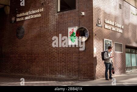 The Guildhall School of Music and Drama, London. A student standing outside the main entrance to the leading performing arts conservatoire. Stock Photo
