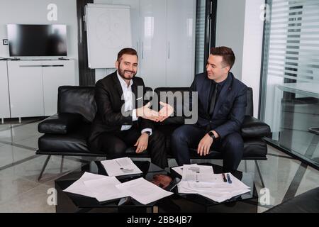 image of a strong handshake between two colleagues after signing a contract Stock Photo