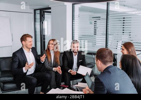 businesspeople discuss financial report in charts diagrams and graphs , business partners analysing common sales statistics presenting deal benefits a Stock Photo
