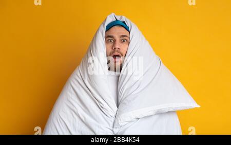 Shocked man in blanket. Stay at home Stock Photo
