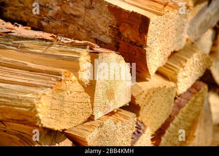 Closeup of a heap of firewood lying piled up in a garden. Seen in Germany in March. Stock Photo