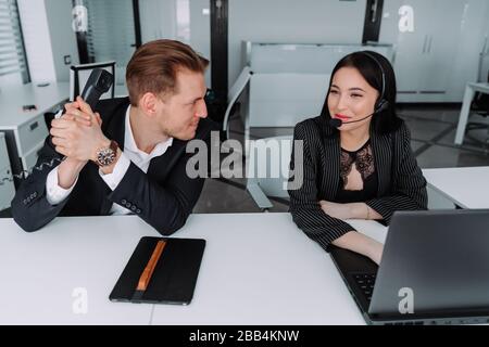 People in the operations center are talking on a landline phone. Operators in the office. Stock Photo
