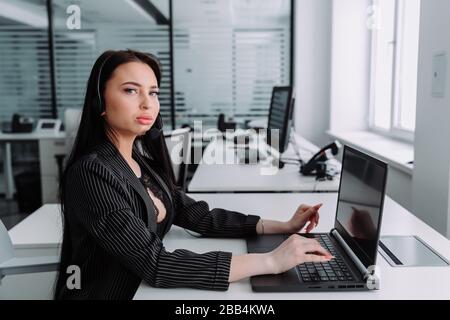 Call center. Focus on the beautiful woman in the headset Stock Photo