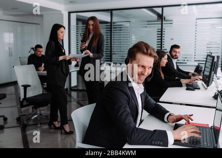 satisfied call center operator look at your laptop Stock Photo