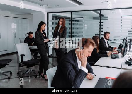 Portrait of business people in suit in a meeting room with laptop computers Stock Photo