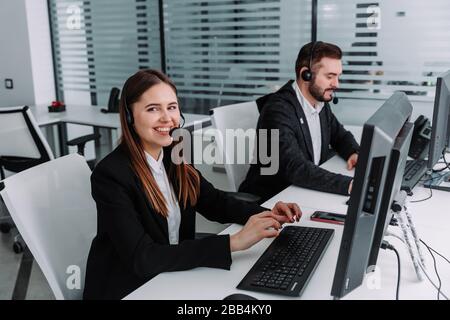 Call center. Focus on the beautiful woman in the headset Stock Photo