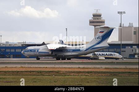 30 March 2020, Spain, Palma de Mallorca: A Russian cargo plane Volga-Dnepr Airlines lands at the airport of Palma de Mallorca. It brings seven tons of medical supplies to the island, which were bought by the Balearic government in the fight against the coronavirus in China. Photo: Clara Margais/dpa Stock Photo