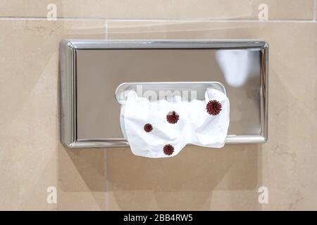 Paper towel hanging on wall with coronavirus cells icons on the surface Stock Photo