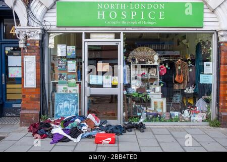 Coronavirus Covid-19 notices in charity shop window in Muswell Hill London , 29th March 2020 Stock Photo