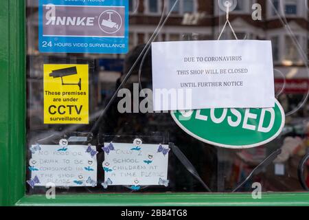 Coronavirus Covid-19 notices in a toy shop  window in Muswell Hill London, 29th March 2020 Stock Photo