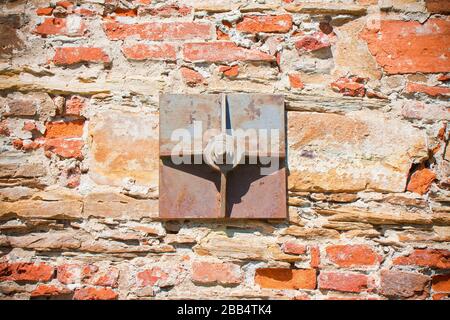 Old brick wall reinforced with metal plates Stock Photo