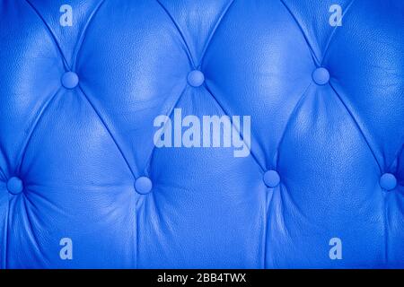 Blue background pattern of a chesterfield buttoned leather sofa Stock Photo
