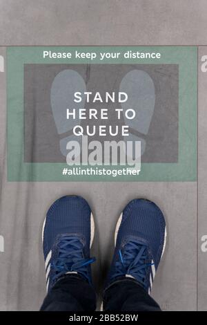 Streatham, UK. 30th Mar, 2020. Stand Here To Queue signs on the floor at a Marks & Spencer supermarket in Streatham in South London, England. ( Credit: Sam Mellish/Alamy Live News Stock Photo