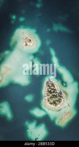 Aerial view shot by a drone of the Eibsee with islands and trees on the ...