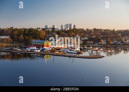 A small marina in the early morning hours against the background of a sleeping town Stock Photo