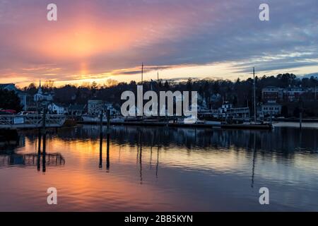 Distant sunset view of Mystic River waterfront in Mystic, Connecticut under colorful skies Stock Photo