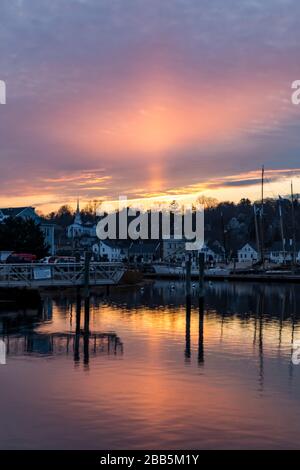 Distant sunset view of Mystic River waterfront in Mystic, Connecticut under colorful skies Stock Photo