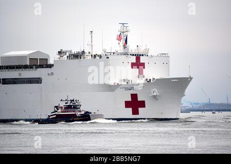 The USNS Comfort arrives in Manhattan to help hospitals handle patients during the coronavirus outbreak in the United States. Stock Photo