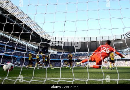 Watford goalkeeper Ben Foster (right) fails to make a save as Manchester City's Riyad Mahrez scores his side's third goal of the game Stock Photo