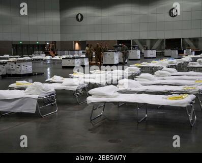 California Air National Guard personnel from the 146th Airlift Wing assist with retrofitting the Los Angeles Convention Center into a federal medical station to treat COVID-19, coronavirus patients March 29, 2020 in Los Angeles, California. Stock Photo