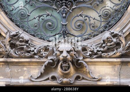 Elements of architectural decorations of buildings, sculptures and statues, public places in Lviv, Ukraine. Sculpture of lion head on the window Stock Photo