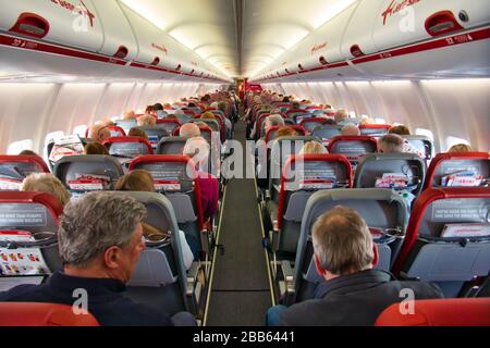 The busy cabin of a Jet2 airplane travelling from Manchester (MAN) to Madeira (FNC) - the plane is G-JZHG, a Boeing 737-85P built in 2020.