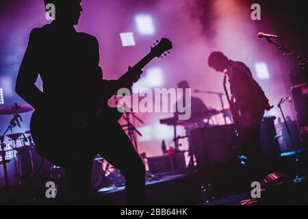 Blurred background light on rock concert with silhouette of musicians Stock Photo