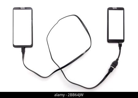 Connecting two smartphones with USB cable to transfer files. Stock Photo