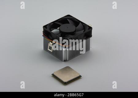 Close-up of Central Processing Unit (CPU) and aluminium cooling fan isolated on white background. Stock Photo