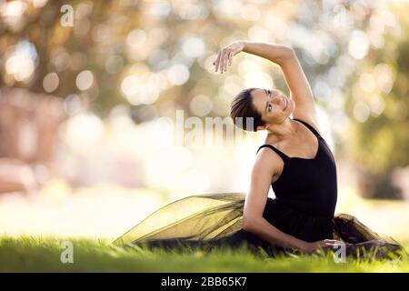 Mid adult woman in a ballet costume stretching. Stock Photo