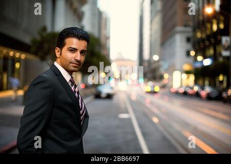 Mid adult businessman writing on a note pad. Stock Photo