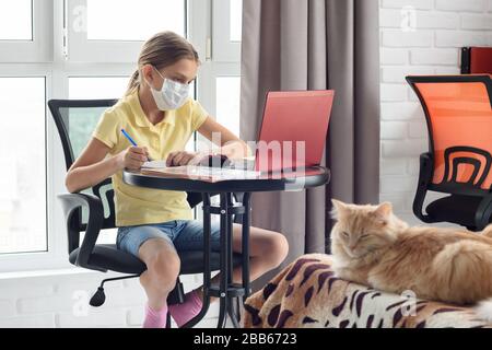 Quarantined girl watching training video lessons in a laptop Stock Photo