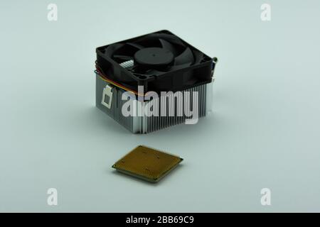 Multi-core Central Processing Unit (CPU) and aluminium cooling fan isolated on white background. Stock Photo