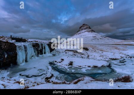 Mt Kirkjufell and Kirkjufellsfoss in the snow, Grundarfjordur, West Iceland, Iceland Stock Photo