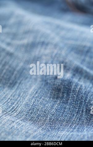 Blue jeans denim fabric close up - jeans fashion concept background, selective focus Stock Photo