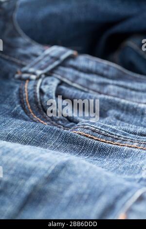 Blue jeans denim fabric close up - jeans fashion concept background, selective focus Stock Photo