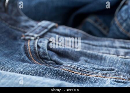 Blue jeans denim fabric close up - jeans fashion concept background, selective focus Stock Photo