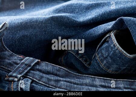 Blue jeans denim fabric close up - jeans fashion concept background, selective focus Stock Photo