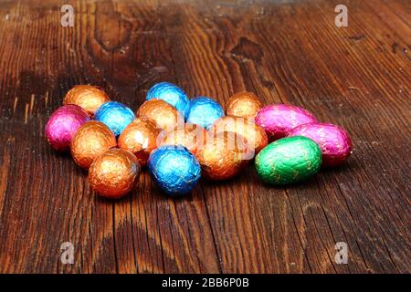 Different colored easter eggs on a wooden board Stock Photo