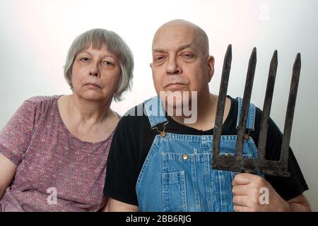 picture of man and woman with pitchfork