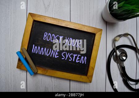 Boost Your Immune System write on a chalkboard isolated on office desk. Stock Photo
