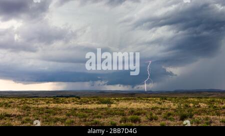 Wall cloud and lightning strike from a supercell thunderstorm in New Mexico Stock Photo