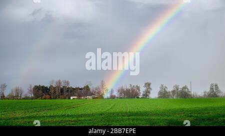 Part of a rainbow after the rain over the Normandy countryside in winter Stock Photo