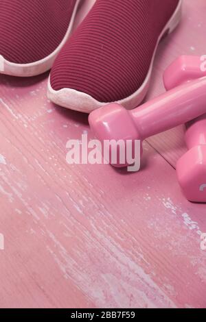 Close up of dumbbell , shoe and water on exercise mat. Stock Photo